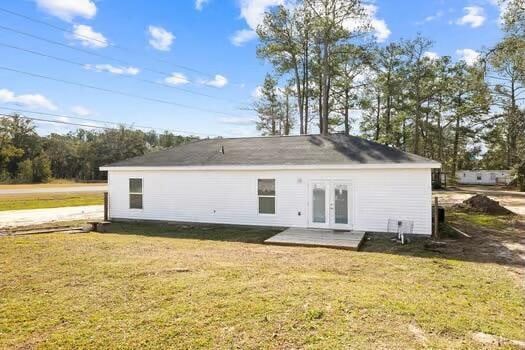 back of house featuring french doors and a yard