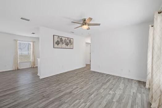 spare room with hardwood / wood-style flooring and ceiling fan