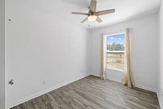 empty room featuring hardwood / wood-style floors and ceiling fan