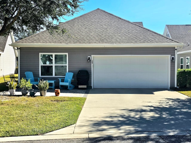 view of front of house featuring a garage and a front lawn