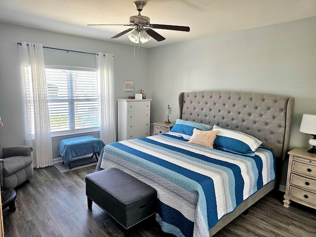 bedroom with dark wood-type flooring and ceiling fan