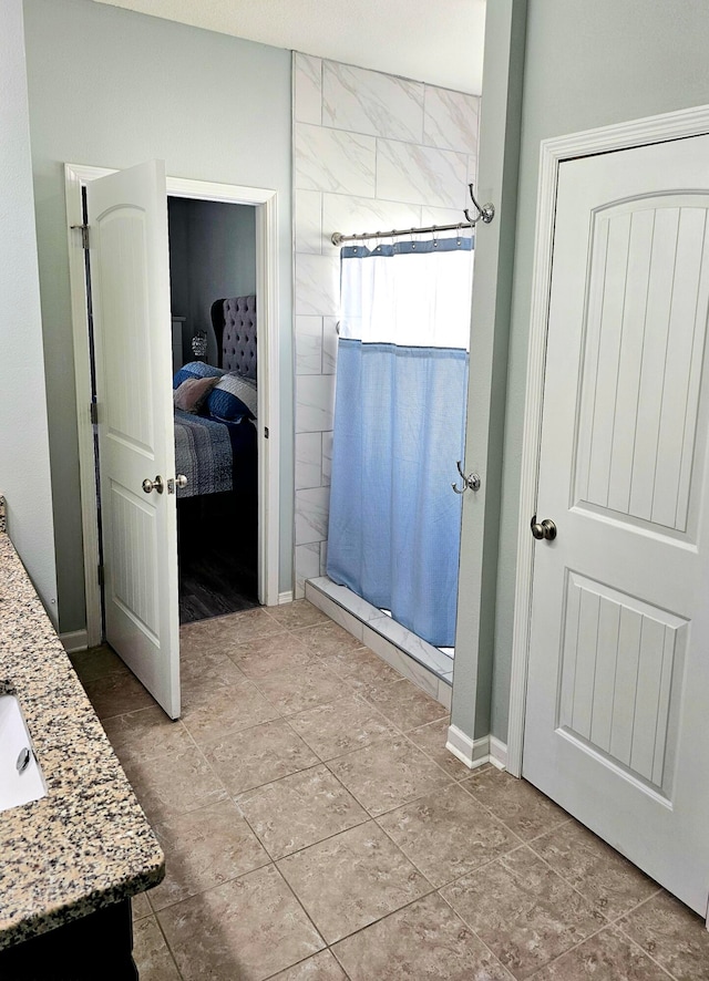 bathroom featuring vanity and tiled shower