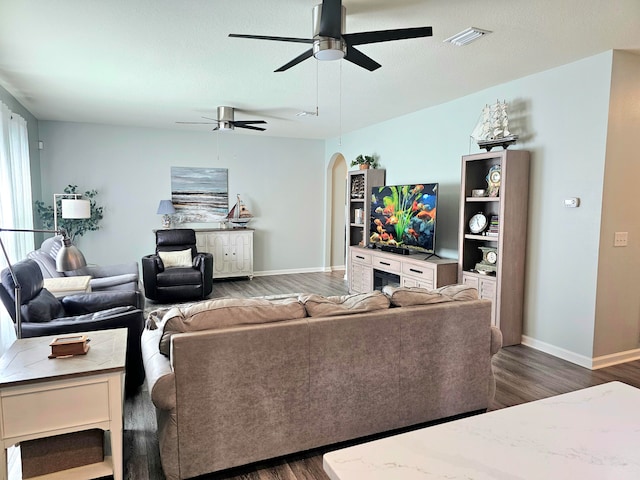 living room featuring dark hardwood / wood-style floors and ceiling fan