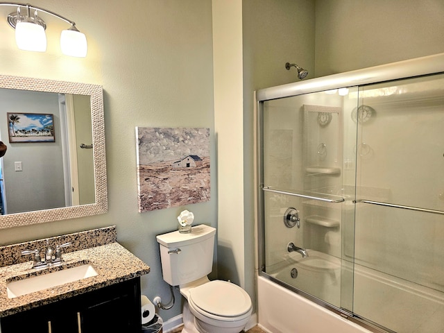 full bathroom with vanity, combined bath / shower with glass door, and toilet