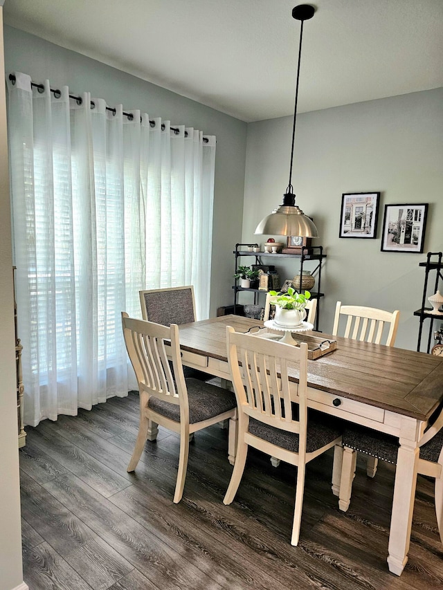 dining space with dark wood-type flooring