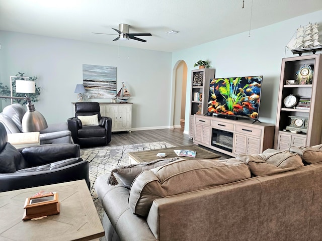 living room with light wood-type flooring and ceiling fan