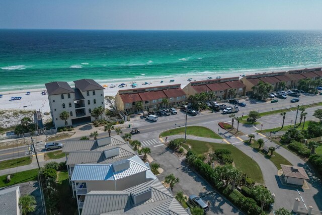 birds eye view of property with a beach view and a water view