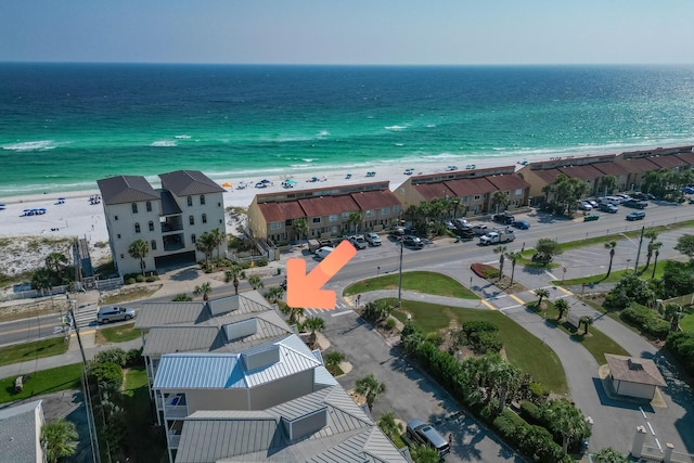 birds eye view of property featuring a view of the beach and a water view