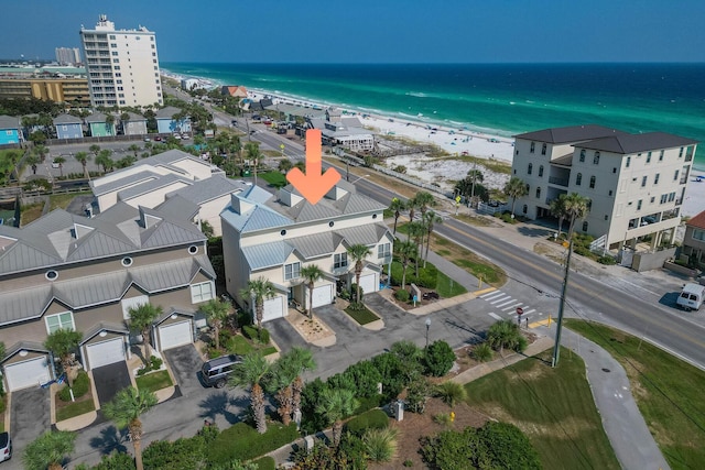 drone / aerial view featuring a beach view and a water view