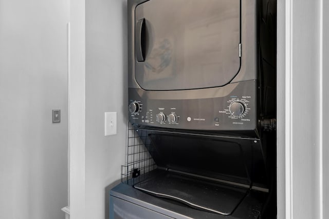 laundry area with stacked washing maching and dryer and laundry area