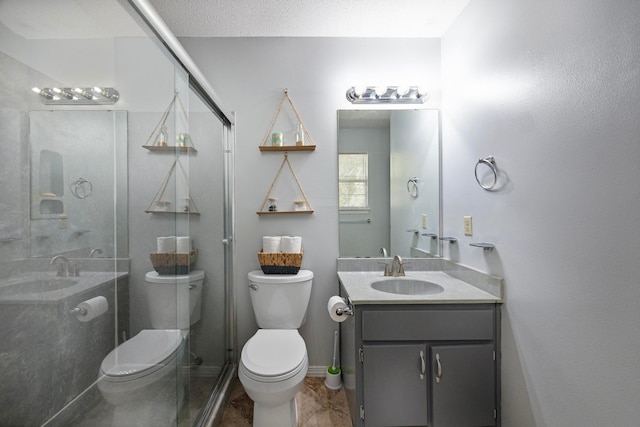 bathroom featuring a shower with shower door, a textured ceiling, toilet, and vanity