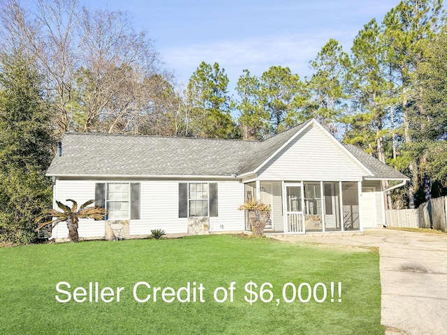 ranch-style home with a front yard and a sunroom