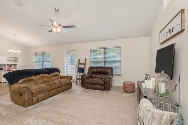 carpeted living room with visible vents, baseboards, ceiling fan with notable chandelier, and lofted ceiling