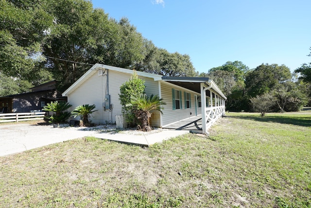 view of side of home with a lawn