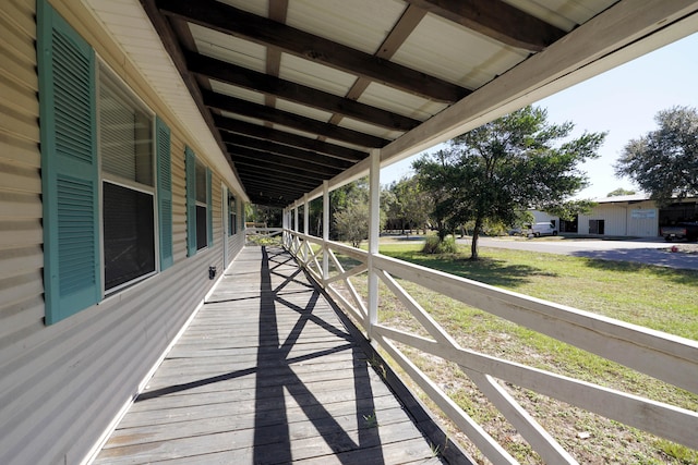 wooden terrace featuring a yard