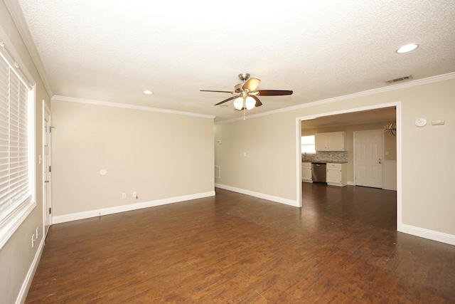 spare room featuring a textured ceiling, crown molding, ceiling fan, and dark wood-type flooring