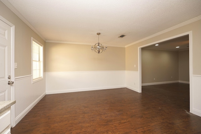 unfurnished room featuring ornamental molding, dark hardwood / wood-style floors, and a notable chandelier