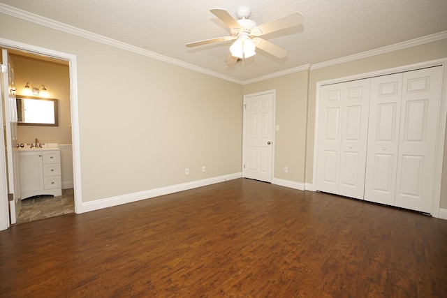 unfurnished bedroom featuring a textured ceiling, ceiling fan, dark hardwood / wood-style flooring, and ensuite bathroom