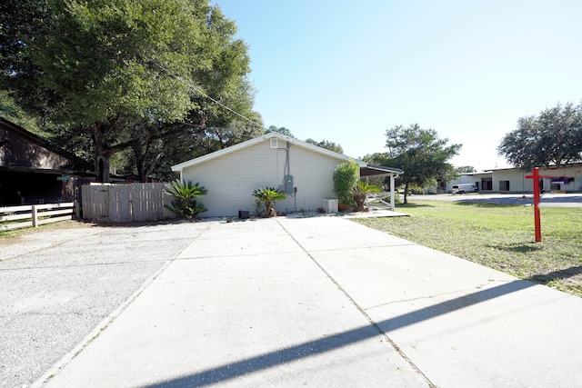 view of side of property with a yard and a carport