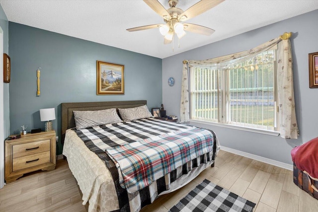 bedroom with light wood-type flooring and ceiling fan