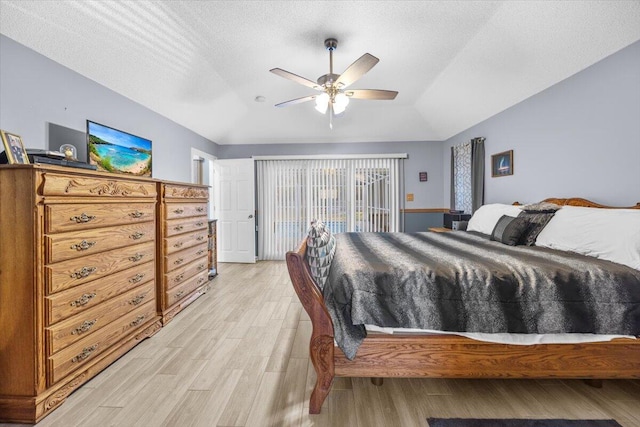 bedroom with a textured ceiling, ceiling fan, and light hardwood / wood-style flooring