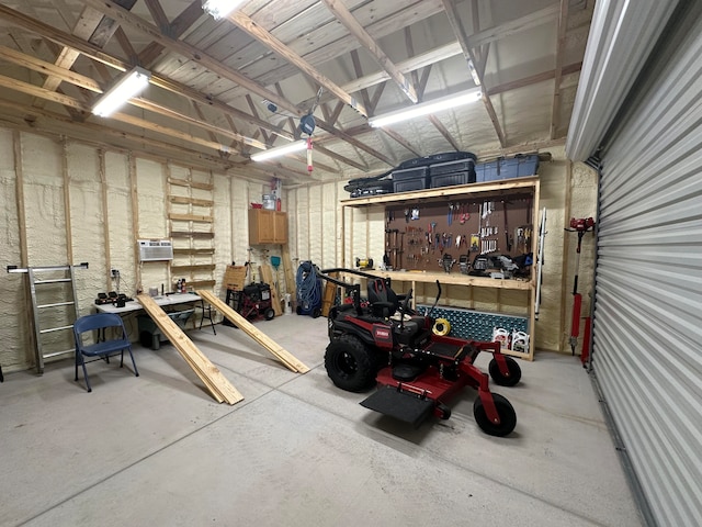 garage with a workshop area and an AC wall unit