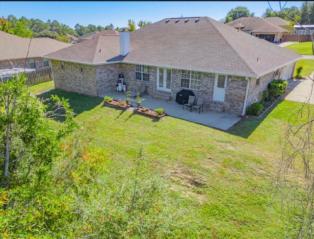 rear view of property with a patio area and a lawn