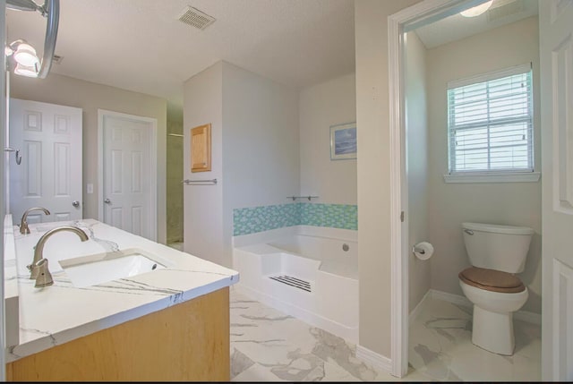 bathroom with vanity, a textured ceiling, toilet, and a bathing tub