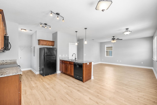 kitchen featuring black appliances, sink, light hardwood / wood-style floors, ceiling fan, and pendant lighting