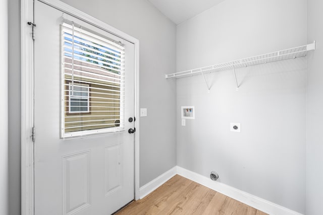 clothes washing area with hookup for an electric dryer, hardwood / wood-style floors, and washer hookup