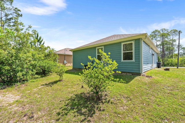 back of house with a lawn