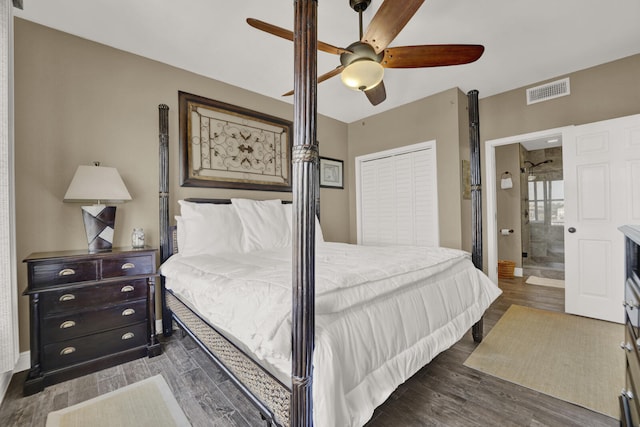 bedroom featuring dark hardwood / wood-style flooring, ensuite bath, a closet, and ceiling fan