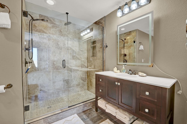 bathroom with vanity and a shower with shower door