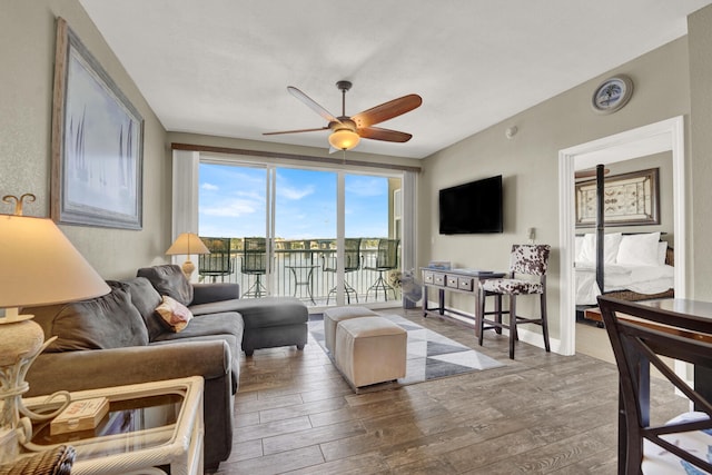 living room featuring wood-type flooring and ceiling fan