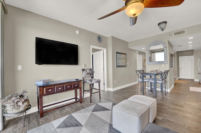 living room with hardwood / wood-style flooring and ceiling fan