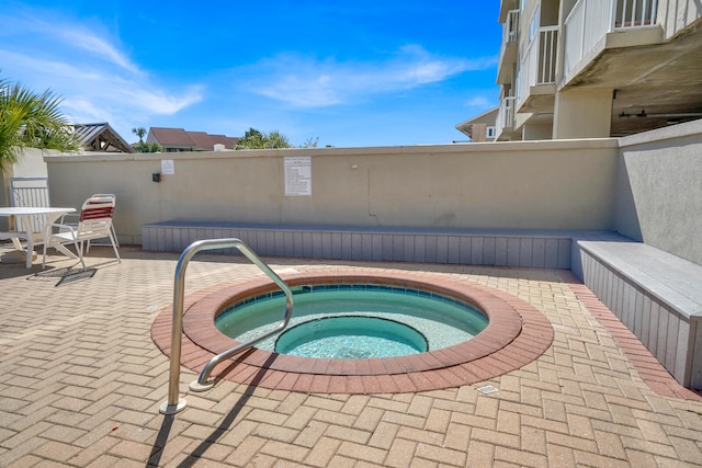 view of swimming pool featuring a community hot tub and a patio area