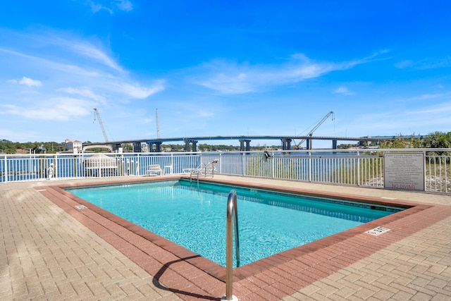 view of pool with a water view