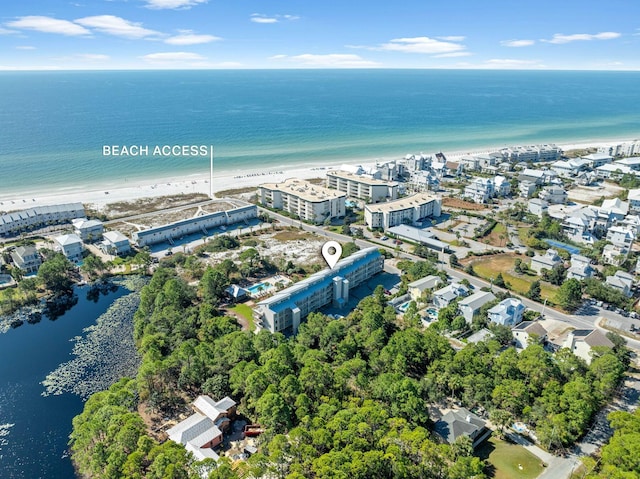 drone / aerial view featuring a water view and a beach view