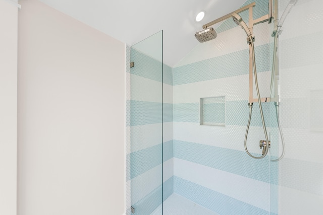 bathroom featuring a stall shower and vaulted ceiling