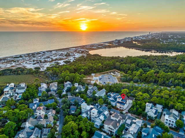 aerial view at dusk with a residential view and a water view