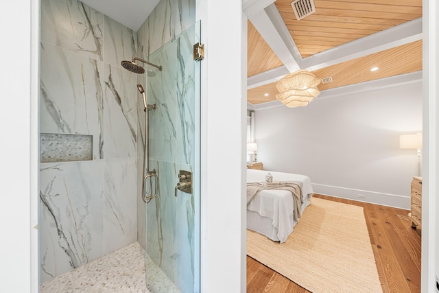 bathroom with a marble finish shower, visible vents, ensuite bathroom, and wood finished floors