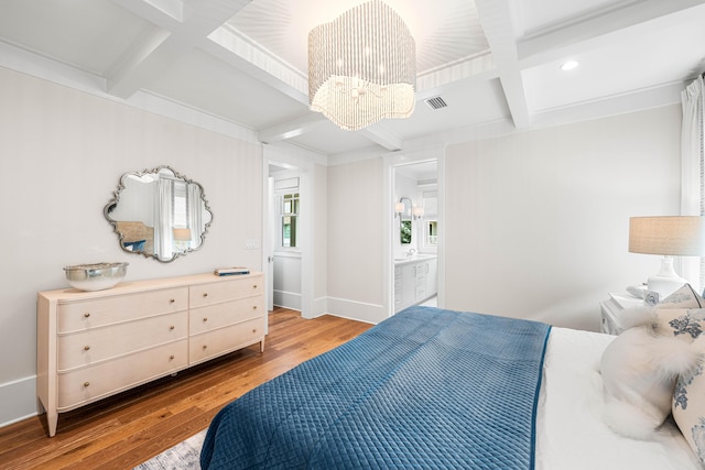 bedroom with visible vents, beamed ceiling, an inviting chandelier, wood finished floors, and coffered ceiling