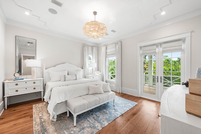 bedroom with access to exterior, visible vents, and wood finished floors