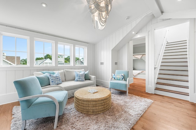 living area with recessed lighting, vaulted ceiling with beams, wood finished floors, and stairs