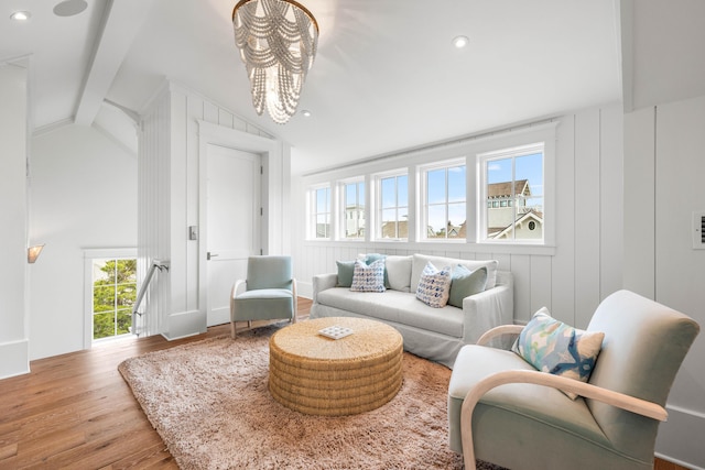 sitting room featuring lofted ceiling with beams, an upstairs landing, wood finished floors, and recessed lighting