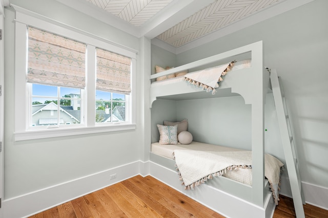 bedroom featuring baseboards and wood finished floors