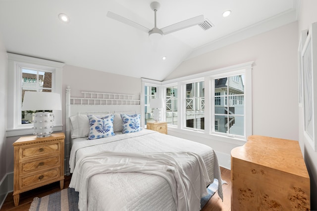 bedroom with vaulted ceiling, visible vents, multiple windows, and wood finished floors