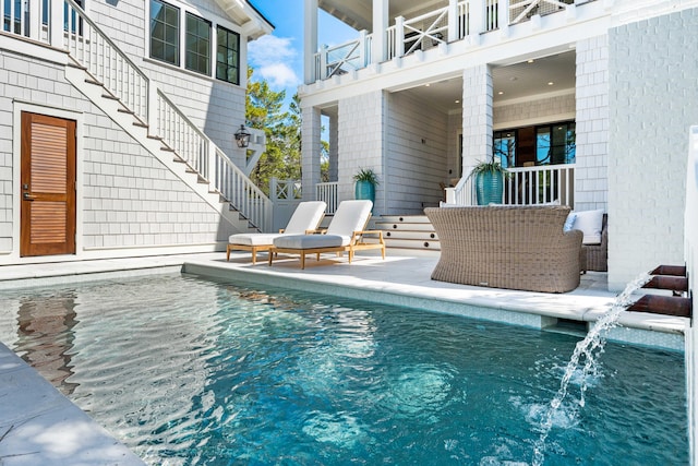 pool with stairway and a patio area