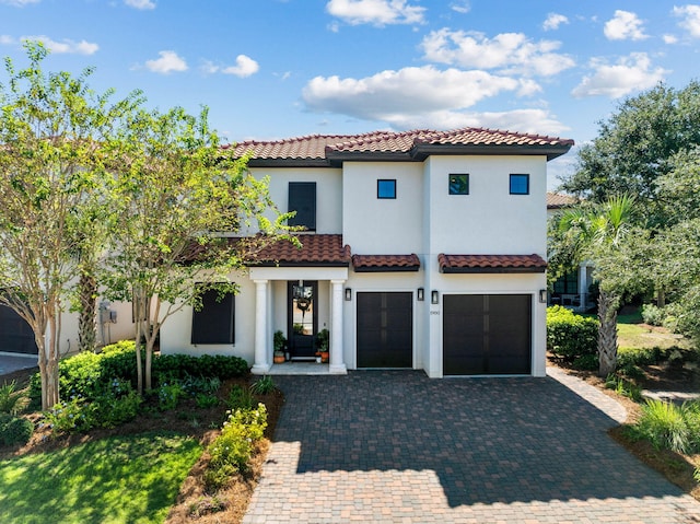 mediterranean / spanish house with a garage