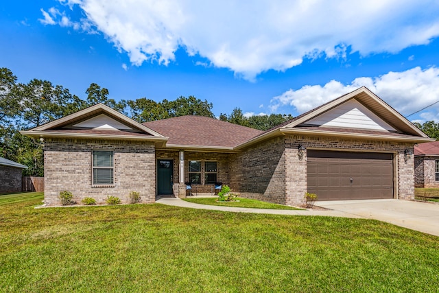 view of front of property with a front yard and a garage